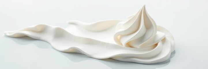 Close-up view of a swirl of whipped cream on a clean white surface, food garnish, culinary detail
