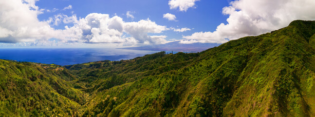 Panorama view to the Hawaiian Island of Maui with cloudy shape and sunset light impressions