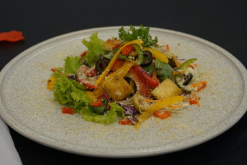 A Plate Fresh Greek vegetable salad with  french potatoes and balsamic sauce in a bowl, delicious food for a restaurant, menu concept, Selective Focus