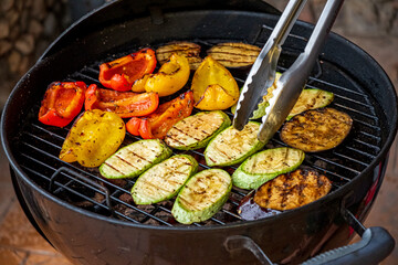 Colorful Vegetables Grilling Over Charcoal in a Cozy Backyard Setting During a Sunny Afternoon Gathering
