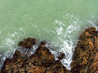 Waves lapping at the rocks along the shore