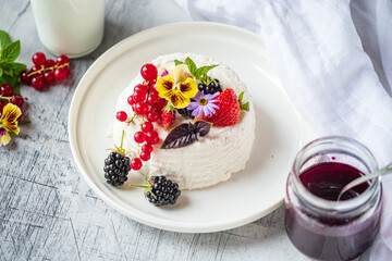 Deliciously Crafted Dessert Garnished With Fresh Berries and Edible Flowers, Inviting a Sweet Experience in a Charming Kitchen Setting