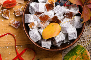 Sweet food Turkish delight on wooden background, assorted locum and candy as decorated backdrop