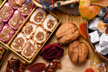 Sweet food Turkish delight on wooden background, assorted locum and candy as decorated backdrop