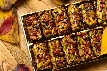 Sweet food Turkish delight on wooden background, assorted pistachio and candy for decorated backdrop
