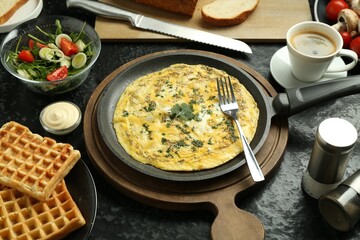 Tasty food served for brunch on black table