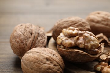 Fresh walnuts with shells on table, closeup