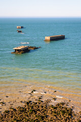 Remains of Phoenix caissons in Tracy-sur-Mer, France, used to build the artificial Mulberry harbour on Gold Beach after the Normandy landings in World War II, seen from Cap Manvieux.
