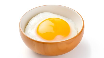 Close up of a raw egg cracked open and sitting in a small white bowl showing the vibrant yellow yolk and translucent egg white in a simple minimalist composition