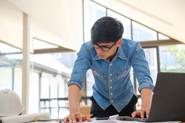 Young architect sketching house plans