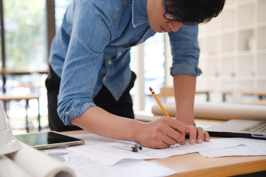 Young architect sketching house plans
