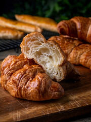 Fresh Baked French Croissants on wooden cafe table.