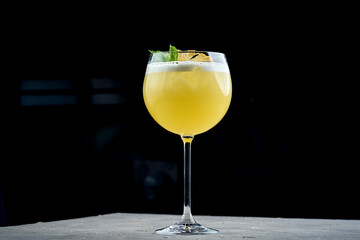 A refreshing pineapple cocktail served in a tall glass, garnished with a fresh pineapple wedge.
