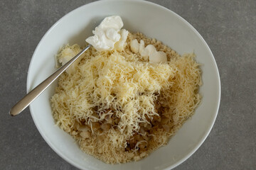 Adding sour cream to the scone ingredients.