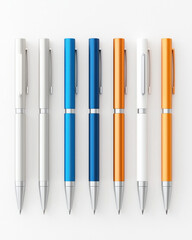 Fototapeta premium Sleek metallic pens in various colors arranged neatly on white background