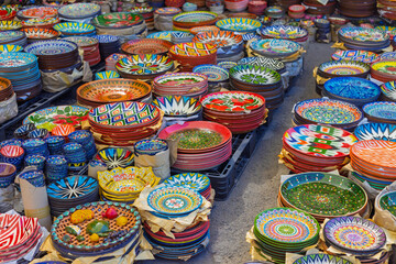 Sale of various colorful plates and bowls with traditional national ethnic Uzbek patterns at the...