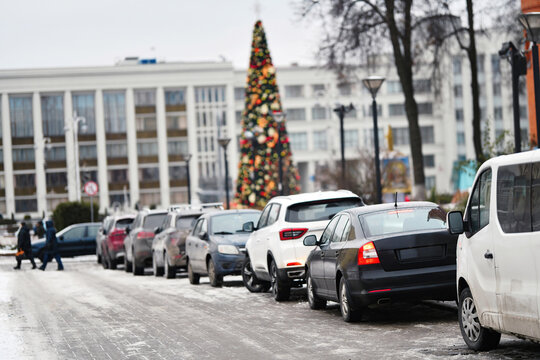 Cars parked in row in the city, roadside parking challenges in urban areas with limited parking space in urban neighborhoods. Tightly parked vehicles on steep road at downtown.