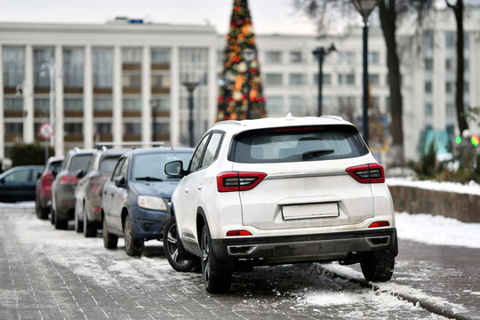 Downtown parking with row of cars tightly lined up in limited spaces, challenges of urban congestion and the struggle for available spots in the city center.