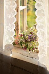 A bouquet of wildflowers in the window.