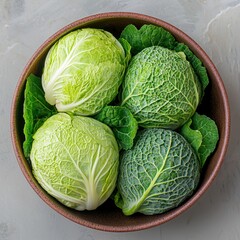 Fototapeta premium Fresh Savoy and Smooth Cabbage Heads Resting in a Bowl, Embracing Wholesome Food Concepts
