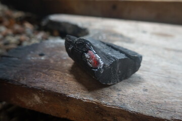 Detailed image showcasing the intense glow of ember charcoal against a dim background, evoking...