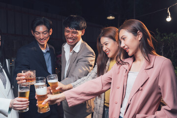 Cheers to Good Times: A group of friends raise their glasses in a toast, their faces lit by the warm glow of string lights as they share laughter and good company.  