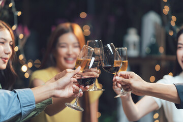 Cheers to Friendship:  Friends raise their wine glasses in a celebratory toast, sparkling lights...