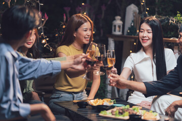 Friends Cheers at Night: A group of happy friends raise their glasses in a toast, their laughter echoing through the warm, inviting atmosphere of a nighttime gathering. The scene is filled with joy.