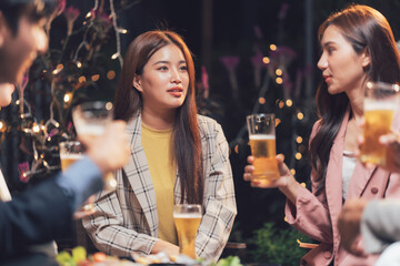 Nightlife Social Gathering: Friends enjoy drinks and conversation at an outdoor evening gathering, creating a warm and inviting atmosphere.  