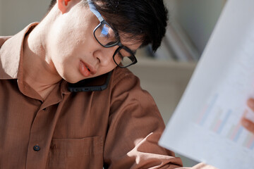 Businessman multitasking while on call office environment professional setting intense focus