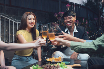 Cheers to Good Times: A group of friends gather around a table, raising their glasses in a toast, their smiles reflecting the joy and camaraderie of a shared moment.