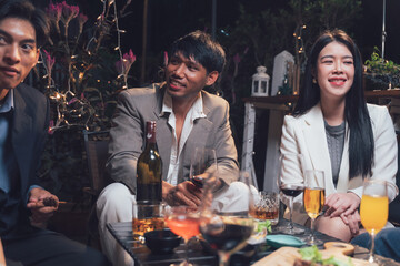 Nightlife Gathering: Friends enjoying a sophisticated evening together, sharing drinks and laughter in a dimly lit, upscale setting.  The scene is filled with warmth, companionship.