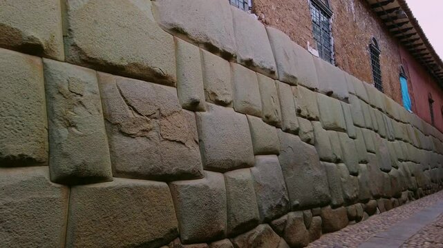Historic Inca stone wall with the famous Twelve-Angled Stone along Hatunrumiyoc Street in Cusco, Peru. Close-up view
