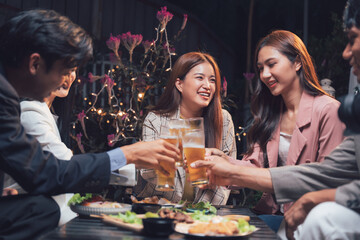 Cheers to Connection: A group of friends raises their glasses in a toast, their smiles radiating warmth and camaraderie as they enjoy a cozy evening gathering.