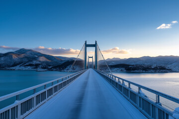 Obraz premium A bridge spans a body of water with a beautiful blue sky in the background