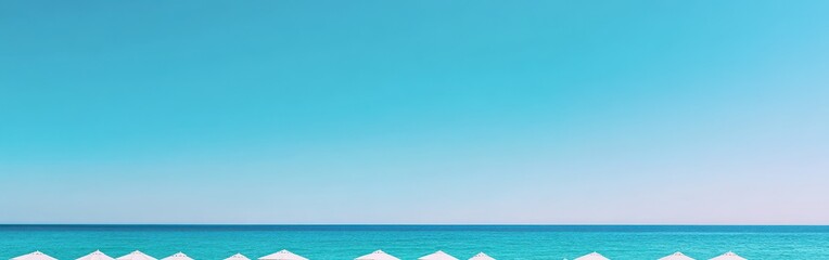 Obraz premium Clear blue sky over calm turquoise ocean with white beach umbrellas.