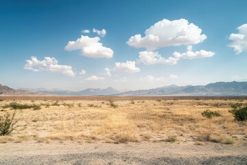 Fototapeta premium Vast desert landscape with fluffy white clouds
