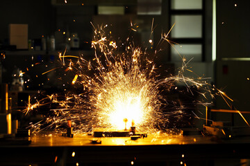 Sparks fly during a laboratory experiment involving electrical discharges and scientific equipment at dusk
