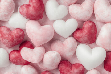 Obraz premium Pastel Red and White Fabric Hearts on Soft Pink Background for Valentine's Day Love Concept