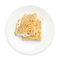 Oatmeal pancake with sour cream and seeds. Diet food. Top view, on a white background, isolate.