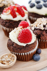 Muffins decorated with fresh fruits and oatmeal flakes. Healthy snack.