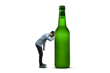 Person leaning sadly against a surreal giant beer bottle isolated from background