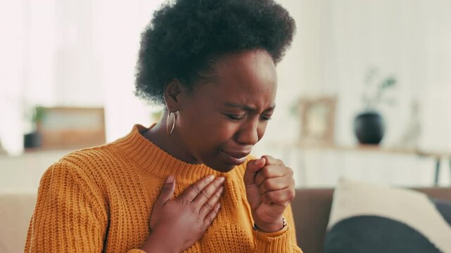 Black woman, cough or virus with sore chest for viral infection, sinus or disease on sofa at home. Female person, flu or sick with allergy, influenza, cold for hayfever, illness or heartburn at house