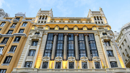 Fototapeta premium Multi-colored facade of an apartment building in Gran Via, Madrid, Spain.