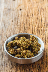 Dried cannabis on wooden background