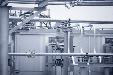 Industry interior of electrical substation with high voltage switches, wires, transformer and ceramic insulators