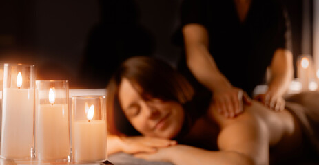 Banner Relaxing massage therapy, young caucasian woman with candlelight ambiance