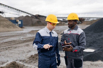 industry workers, Mining engineers in sand quarry discussing project details with digital tablet