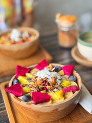 Smoothie bowl with bananas, berries, granola and other ingredients