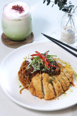 a plate of crispy chicken pasta with xo sauce